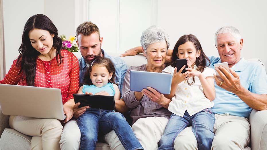 Family Using Technology From Stone