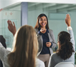 A woman answering peoples questions at work