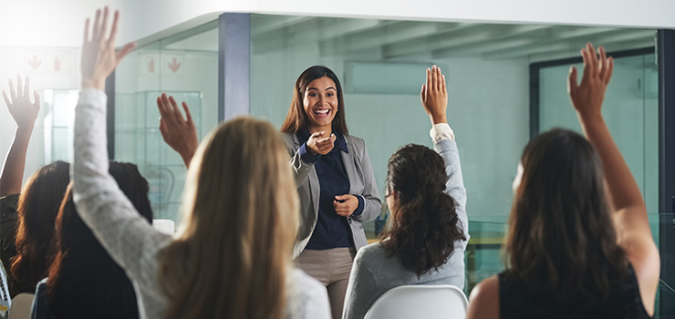 A woman answering peoples questions at work