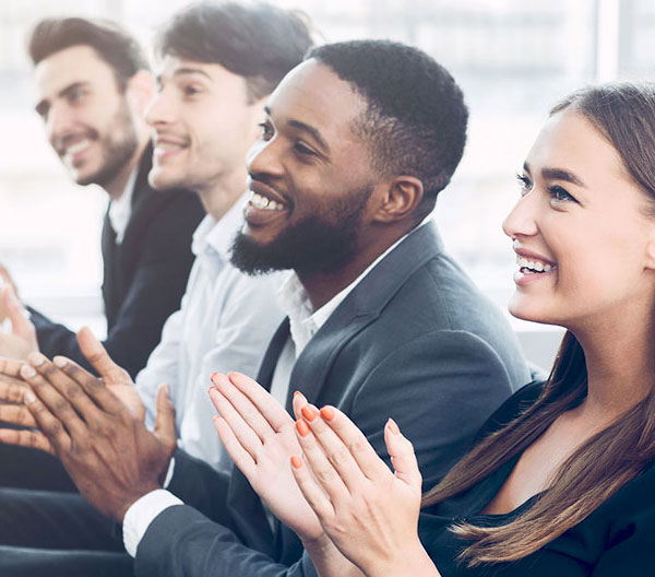 A mixed group of people clapping