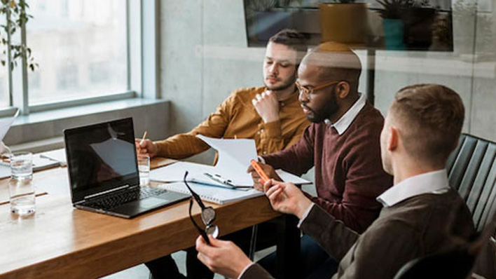 3 people at work with a laptop