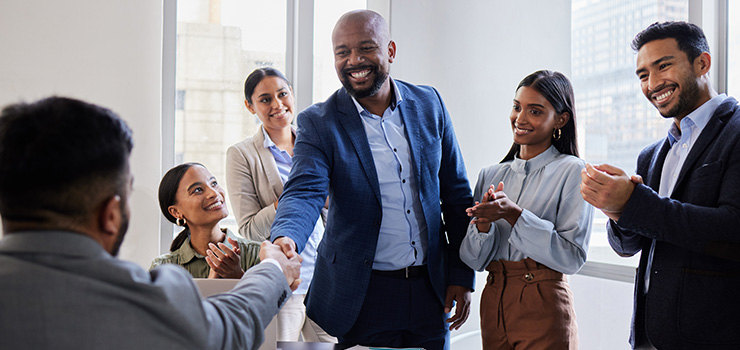 A man shaking hands with someone at work