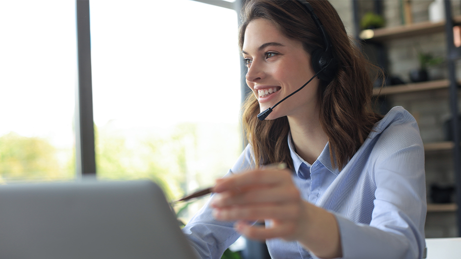 Woman talking on headset consulting client