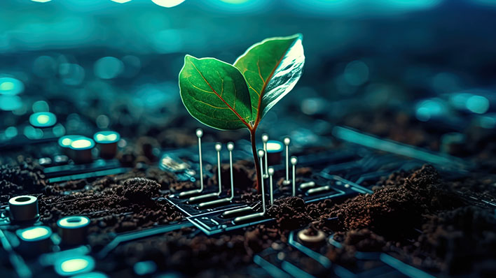 Sustainable Technology - A plat growing out of a computer chip